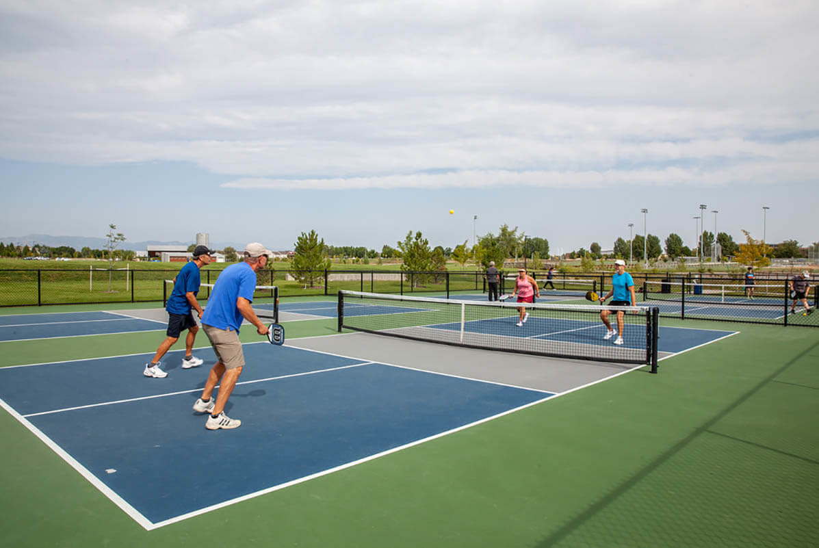 Playing tennis at Twin Silo Park in Fort Collins