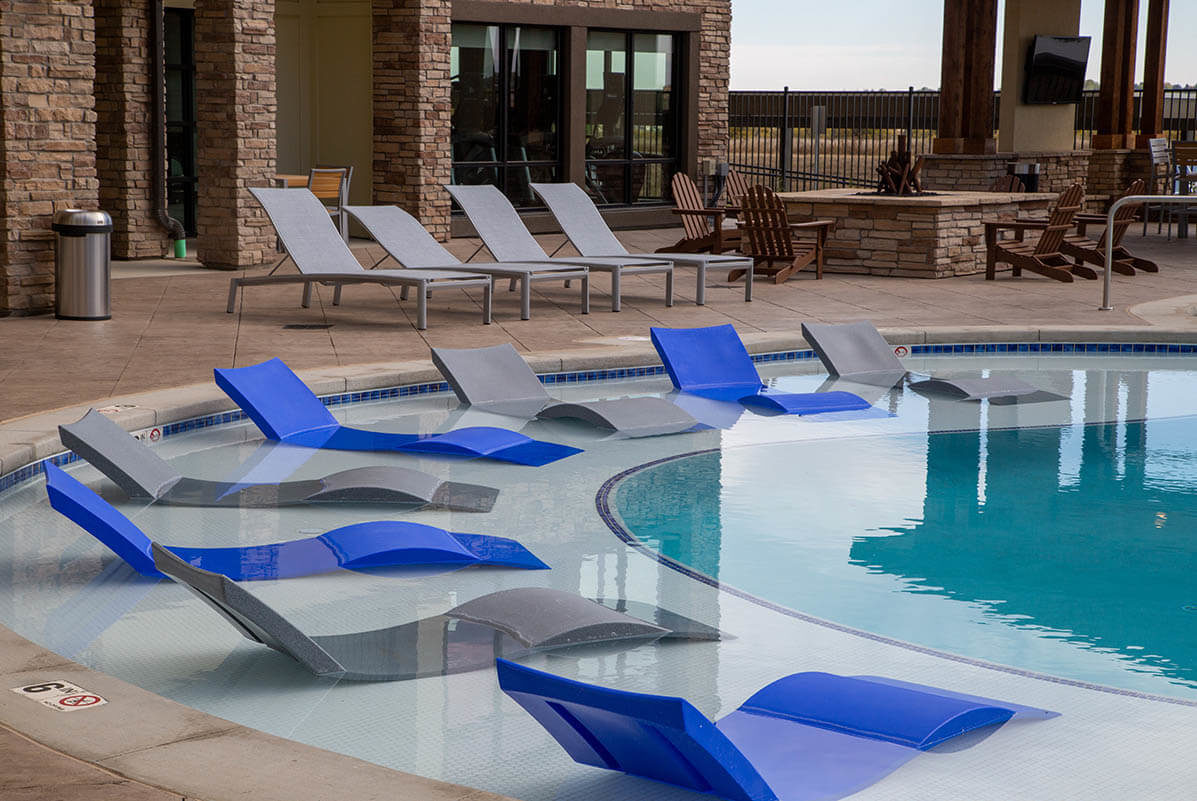 Pool and chairs at Rise Luxury Apartments Johnstown, CO